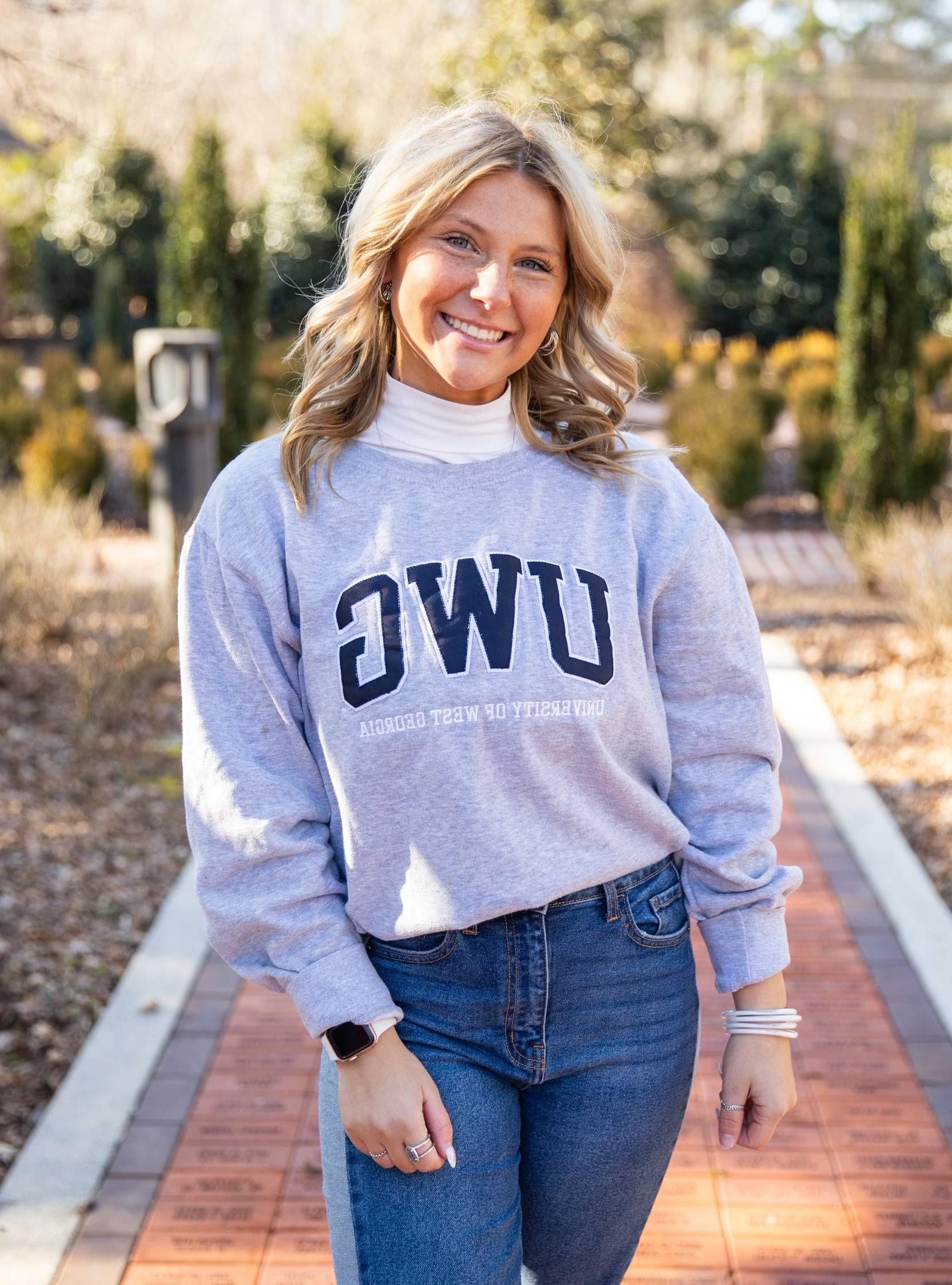 Emily Howie posing for an outside portait in the alumni garden.