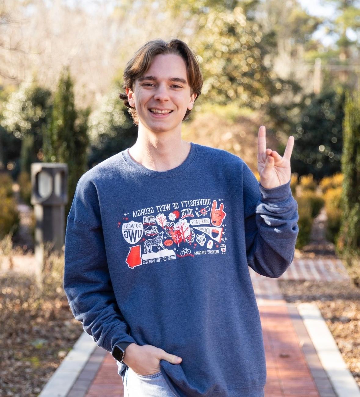 Connor Tipton posing for an outside portait in the alumni garden.