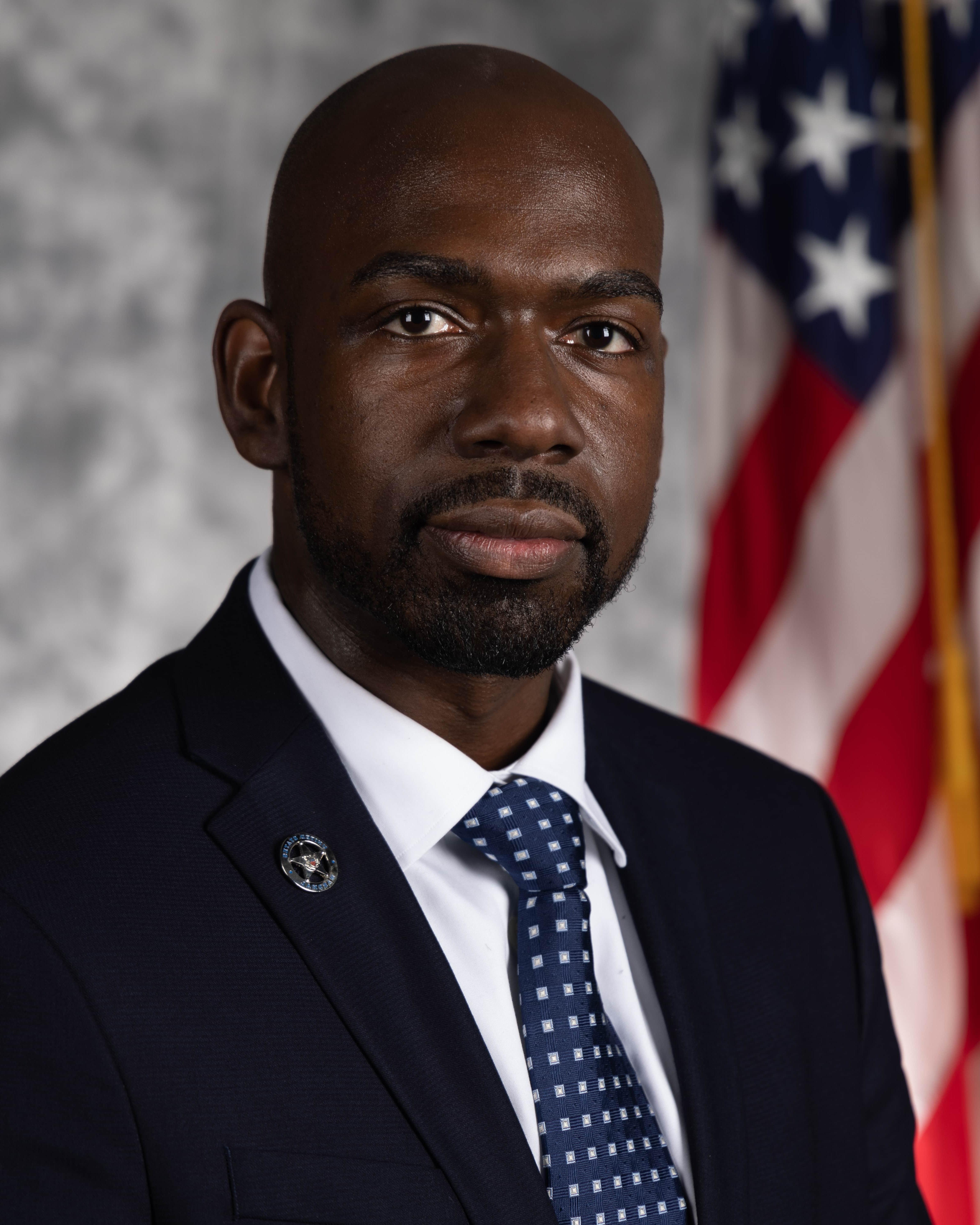 Michael McDowell wearing a suit for a professional headshot.